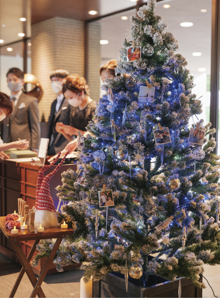 写真：ウエルカムスペースのクリスマスツリーに思い出の写真を飾り、フォトウォールに